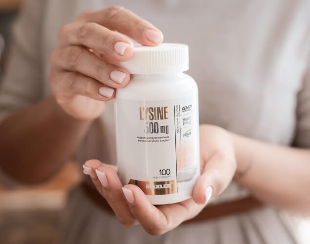 A plastic can with Lysine-500 in hands