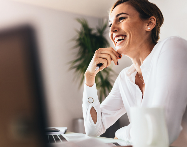 A photo of a woman laughing.